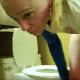 A girl with a tattoo on her ass pulls out her tampon and then takes a shit while standing over her toilet. The urge strikes a second time, and she shits again before finishing wiping her ass. About 3 minutes.